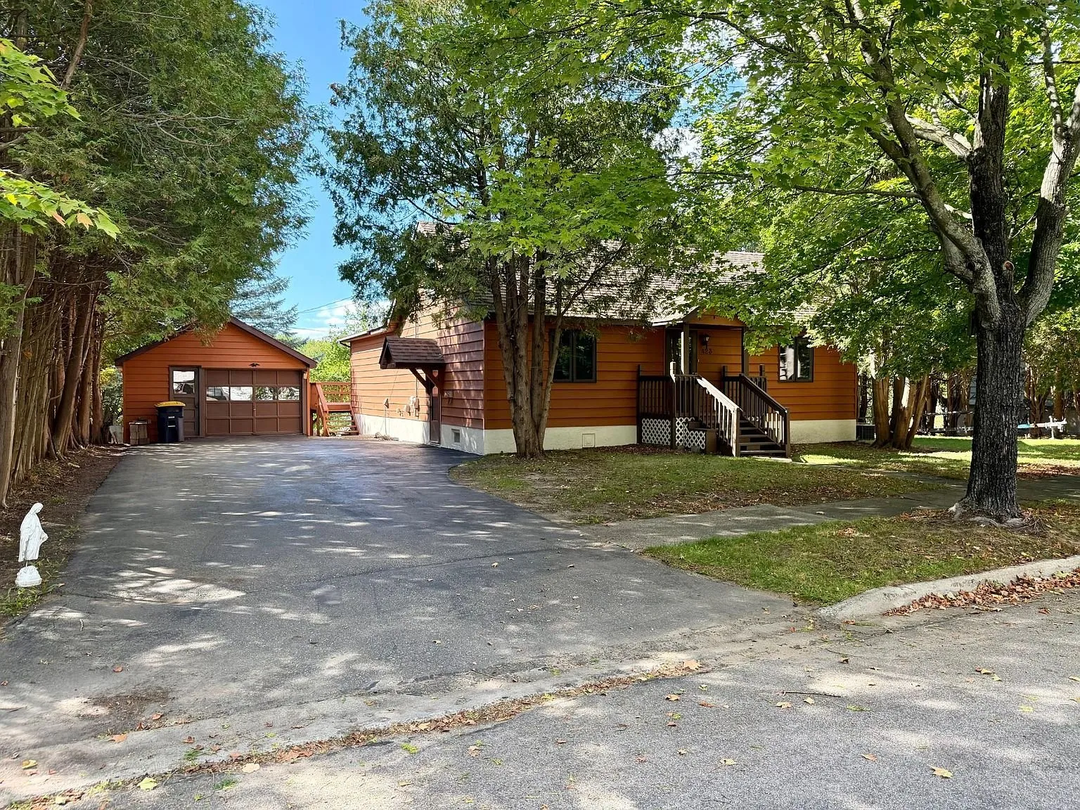 The paved drive with the garage at the end and the house beside it