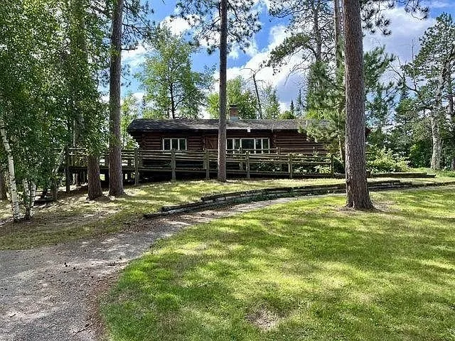 The first cabin on its walkout basement above the lawn with the deck along the front