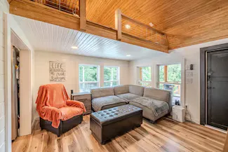 The living area with a ladder leading up to the loft bedroom