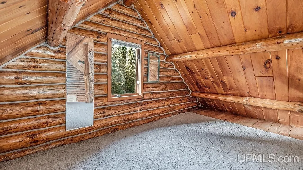The cabin's front deck and shuttered windows from the lawn