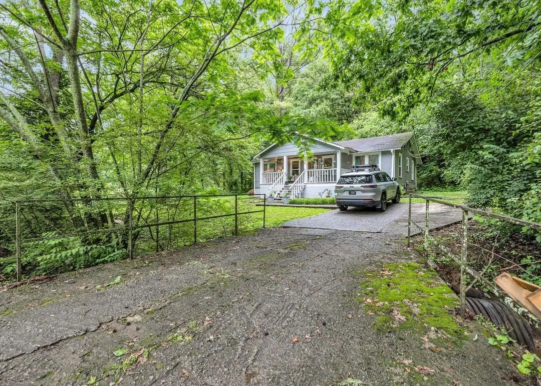 The home's exterior seen from the wooded driveway