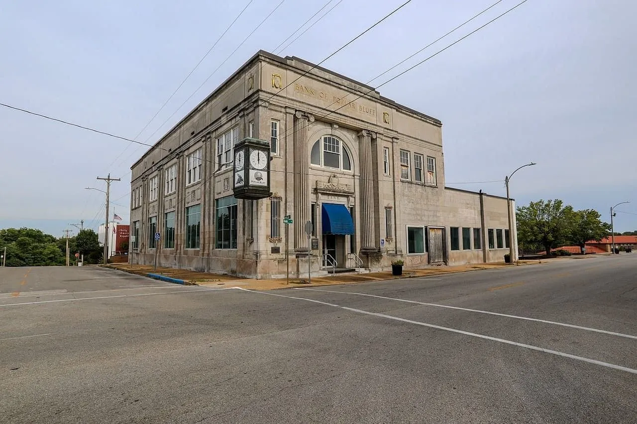 The building from the far corner, two storeys of limestone on a brick block