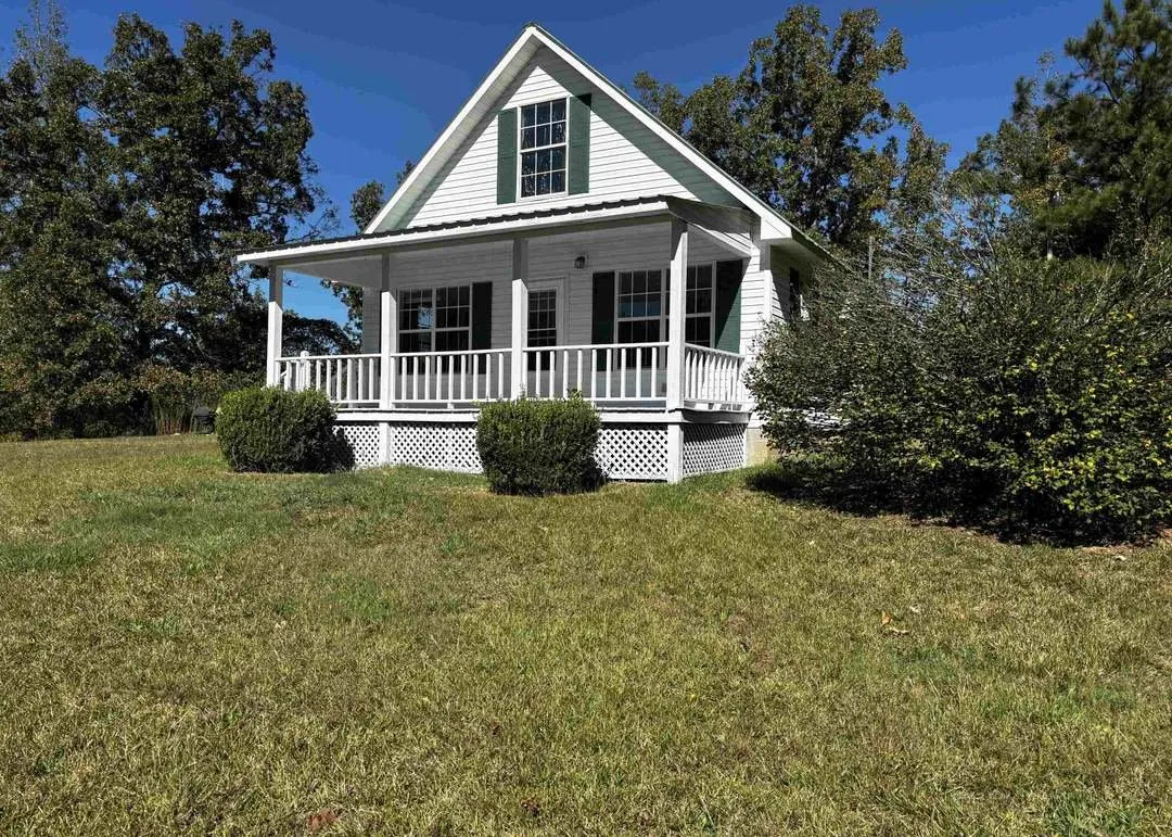 The home seen from a second angle across the mowed lawn