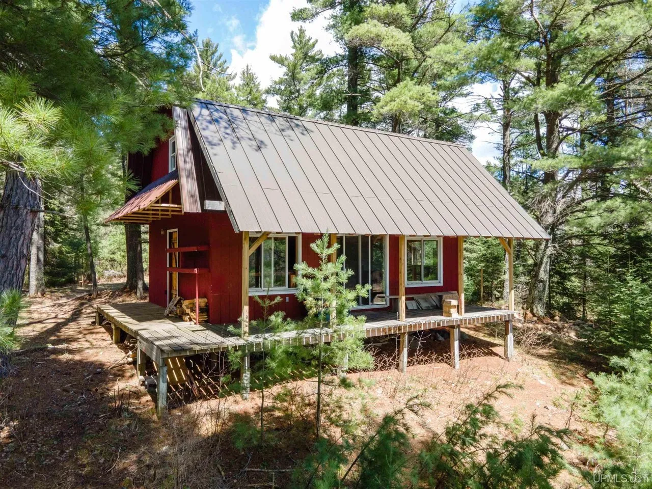 The camp from the drive, deck and steps up to the door