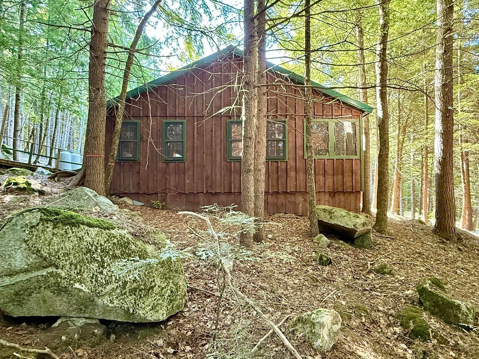 The camp from below with a boulder in the foreground