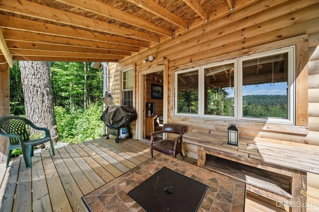 The covered deck running along the front of the cabin