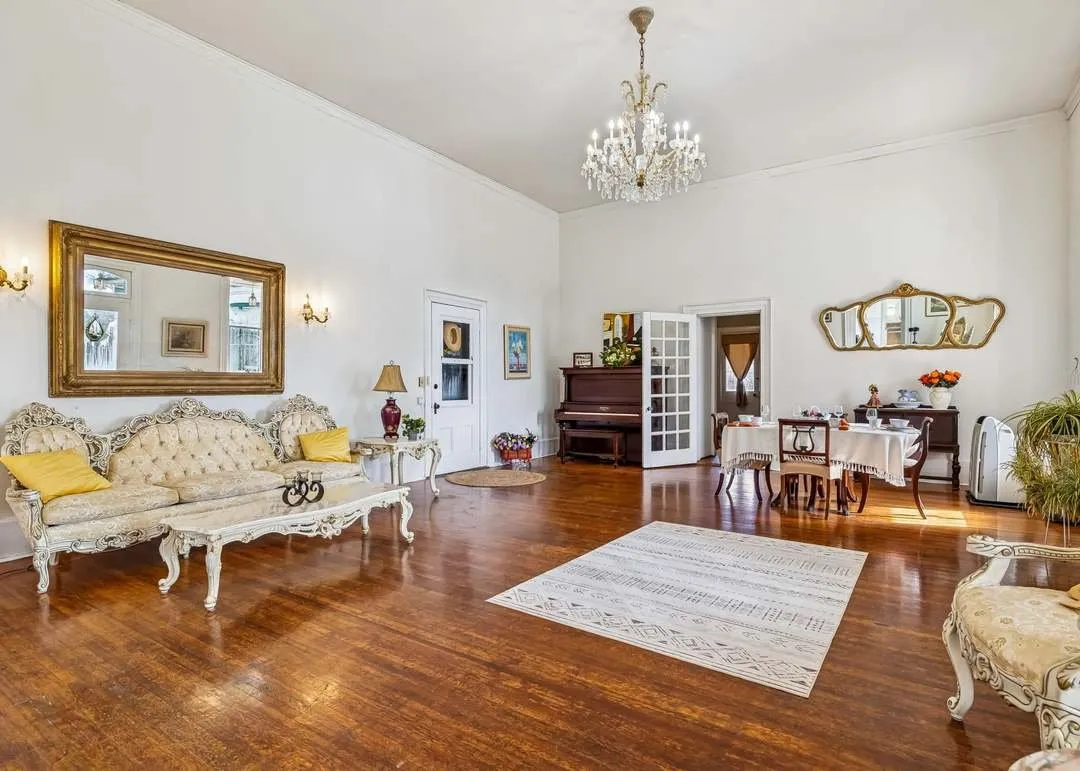 The formal parlor with period furnishings and a chandelier