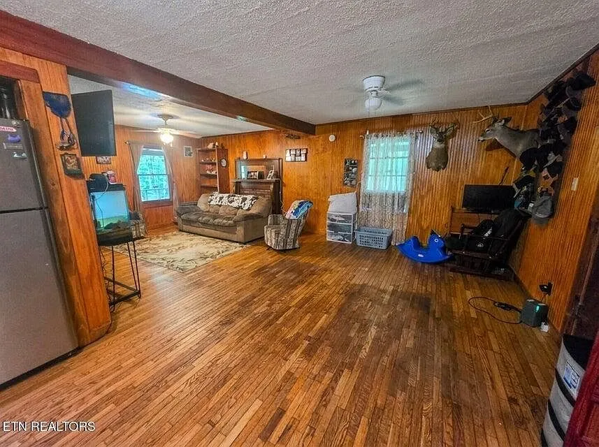 A second living room view showing the open floor plan toward the kitchen and a mounted deer head