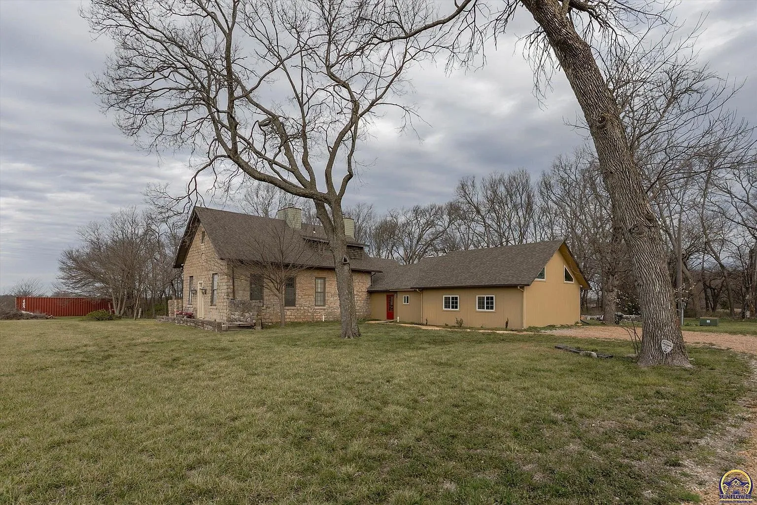 The stone schoolhouse with the tan addition running behind it