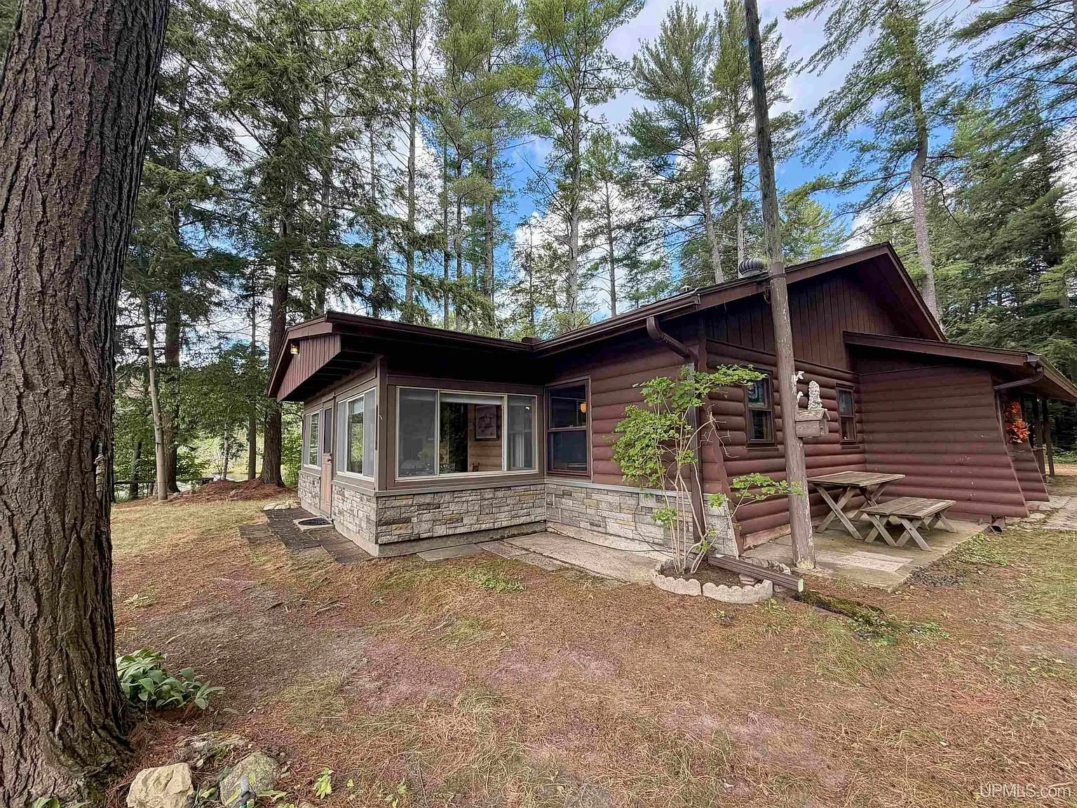 The cabin with the glassed three-season room on the lake end