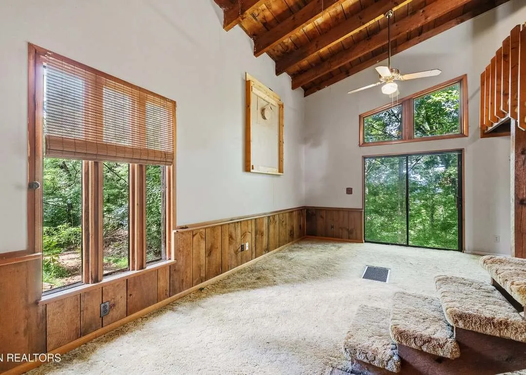 The vaulted loft level with exposed timber framing and a handmade staircase