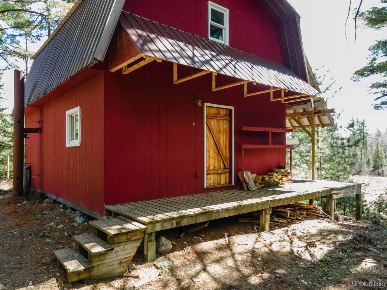 The front of the camp with the porch roof extending over the deck