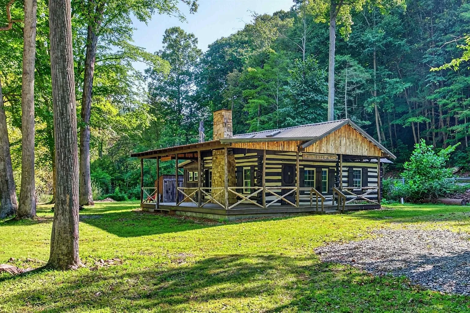 The cabin among the trees with its covered porch