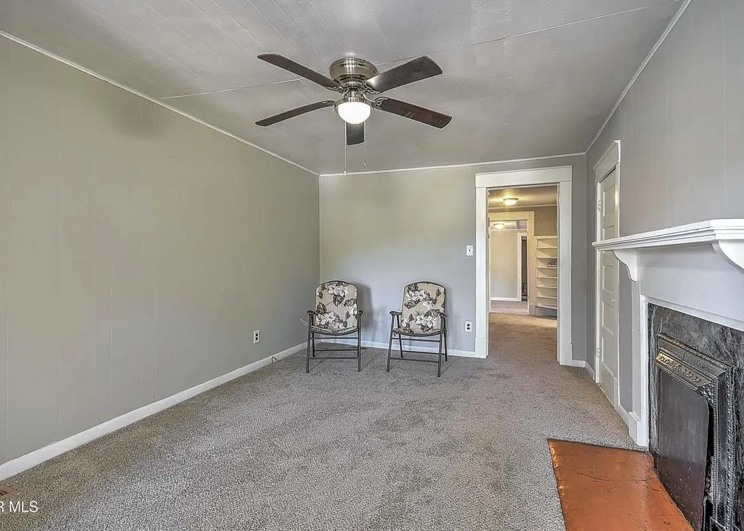 The living room with a fireplace and two chairs