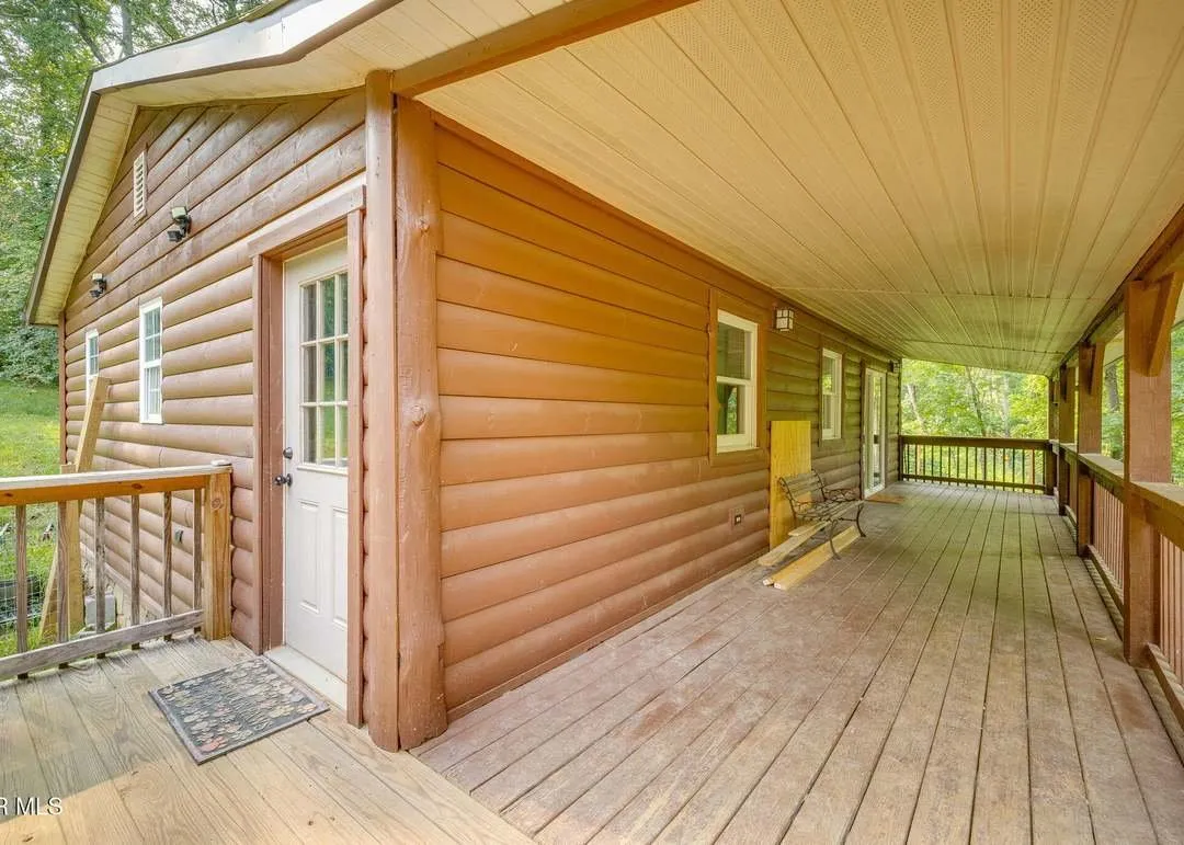 The covered porch running the full length of the home