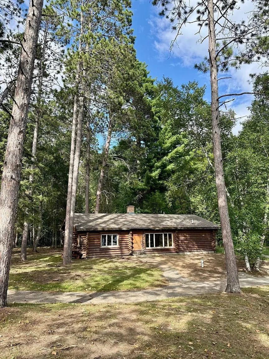 The second cabin among the pines with the lake behind