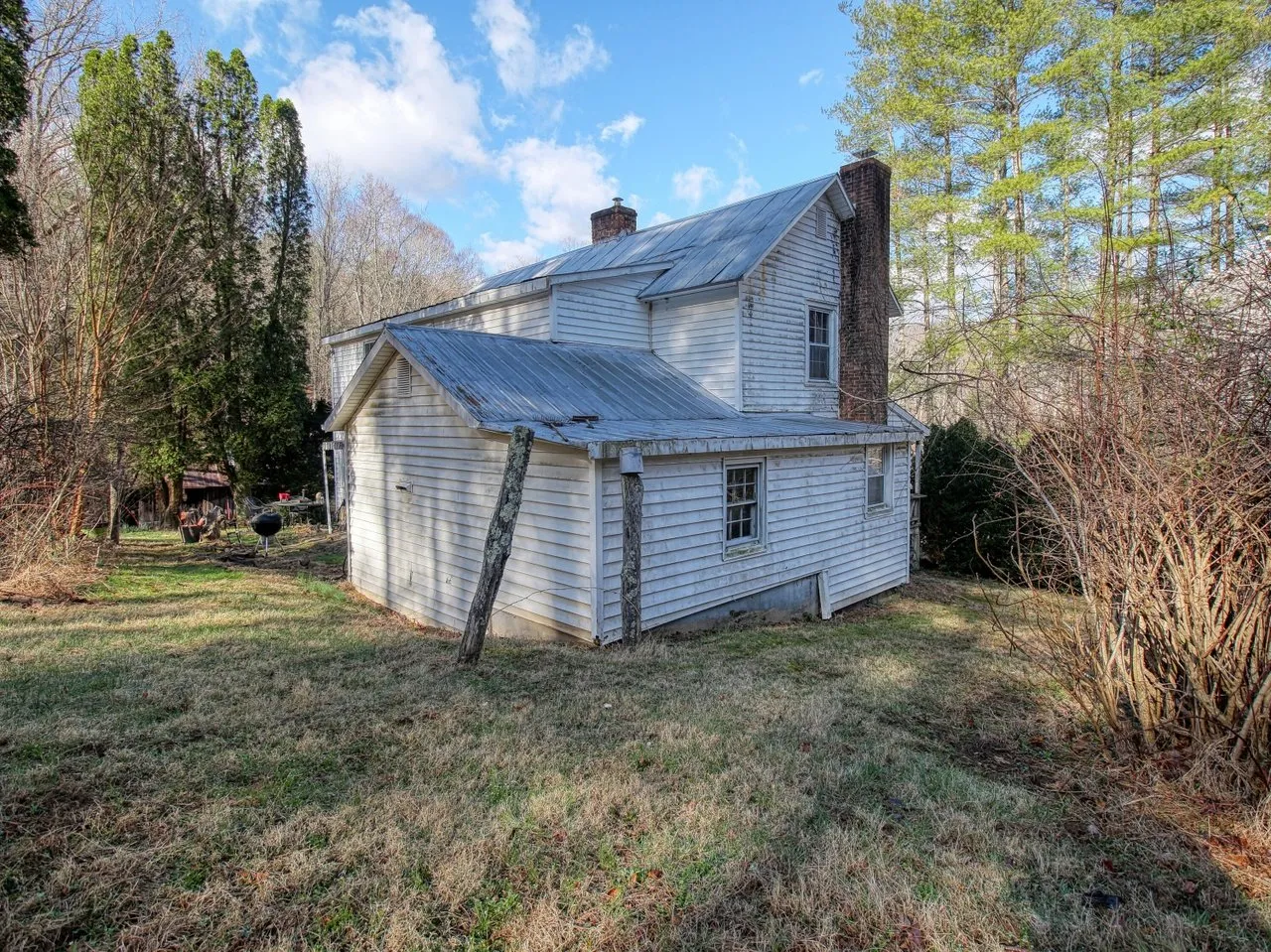 The rear of the house with its brick chimney and a one-story addition