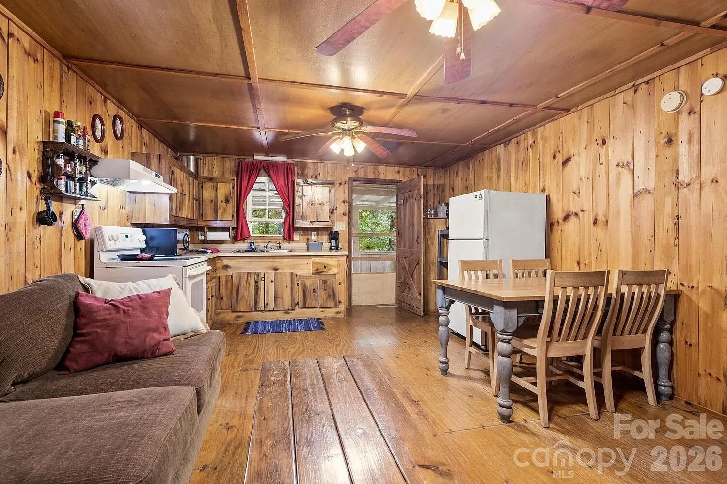 The main room toward the kitchen with the dining table and the refrigerator
