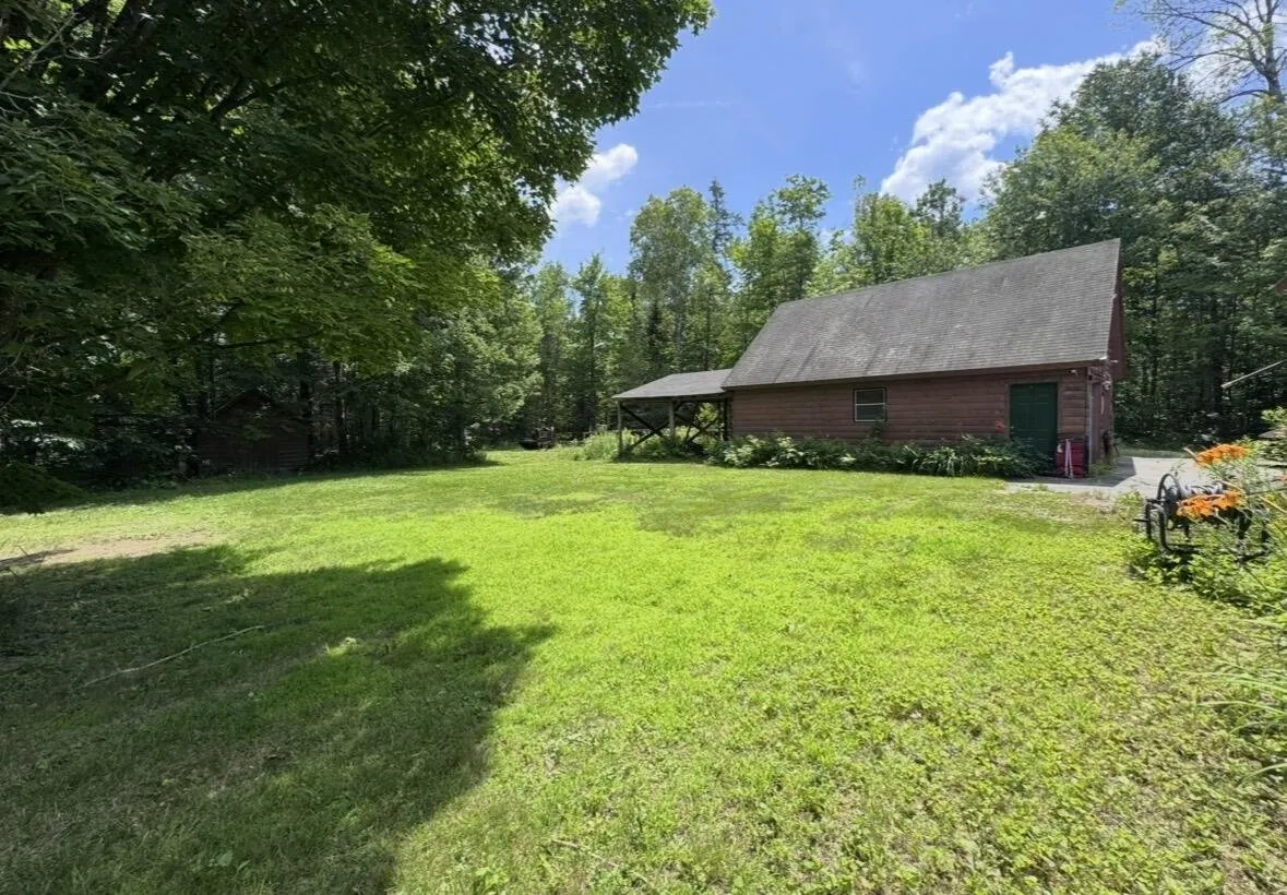 The garage and its lean-to from the back lawn