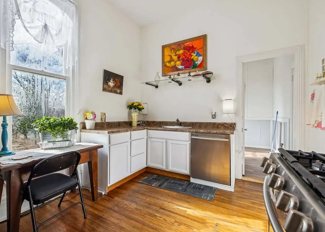 The kitchen with white cabinets and stainless appliances