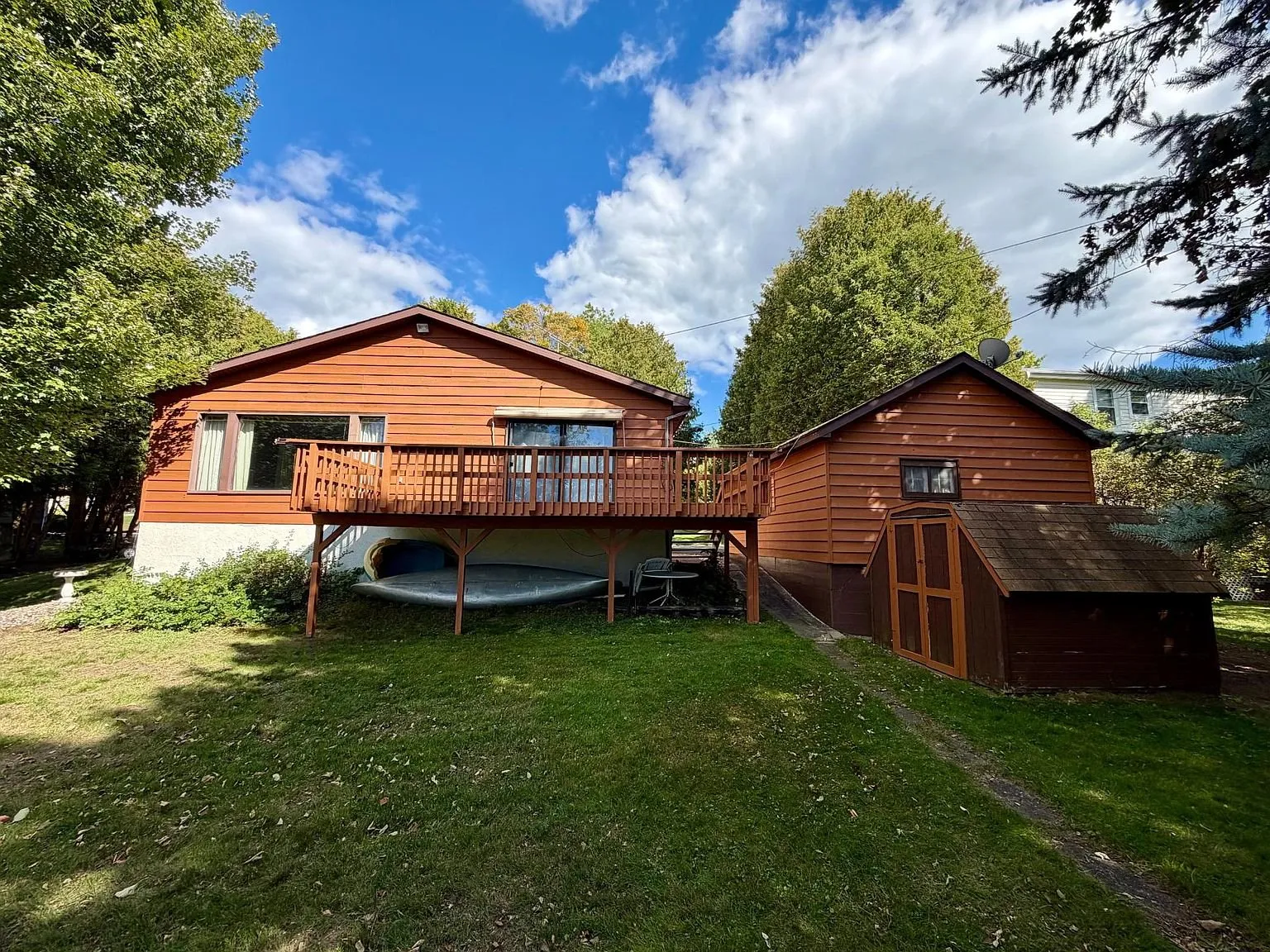 The back of the house with the deck and the shed