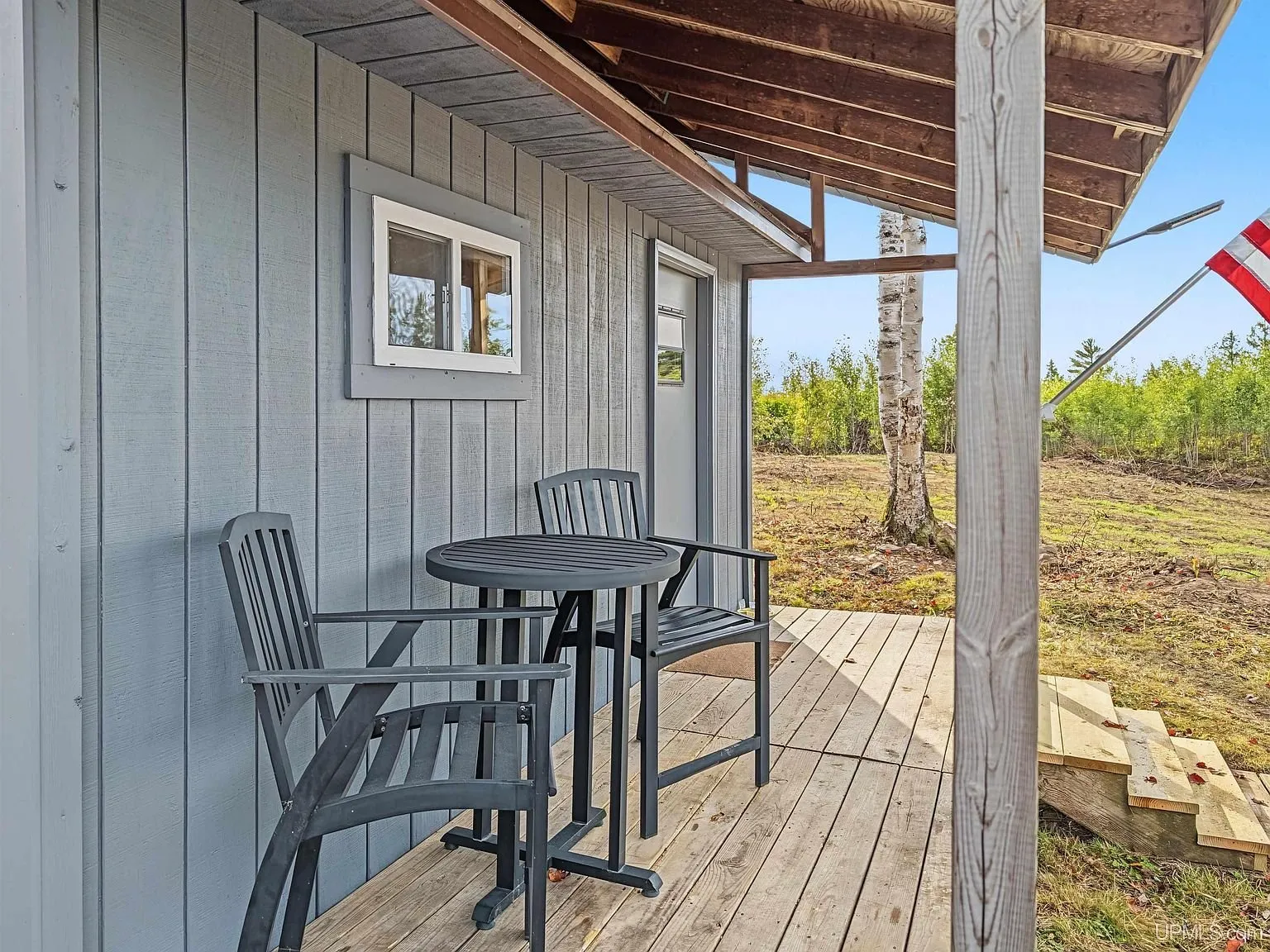 The covered porch and entry door from the yard