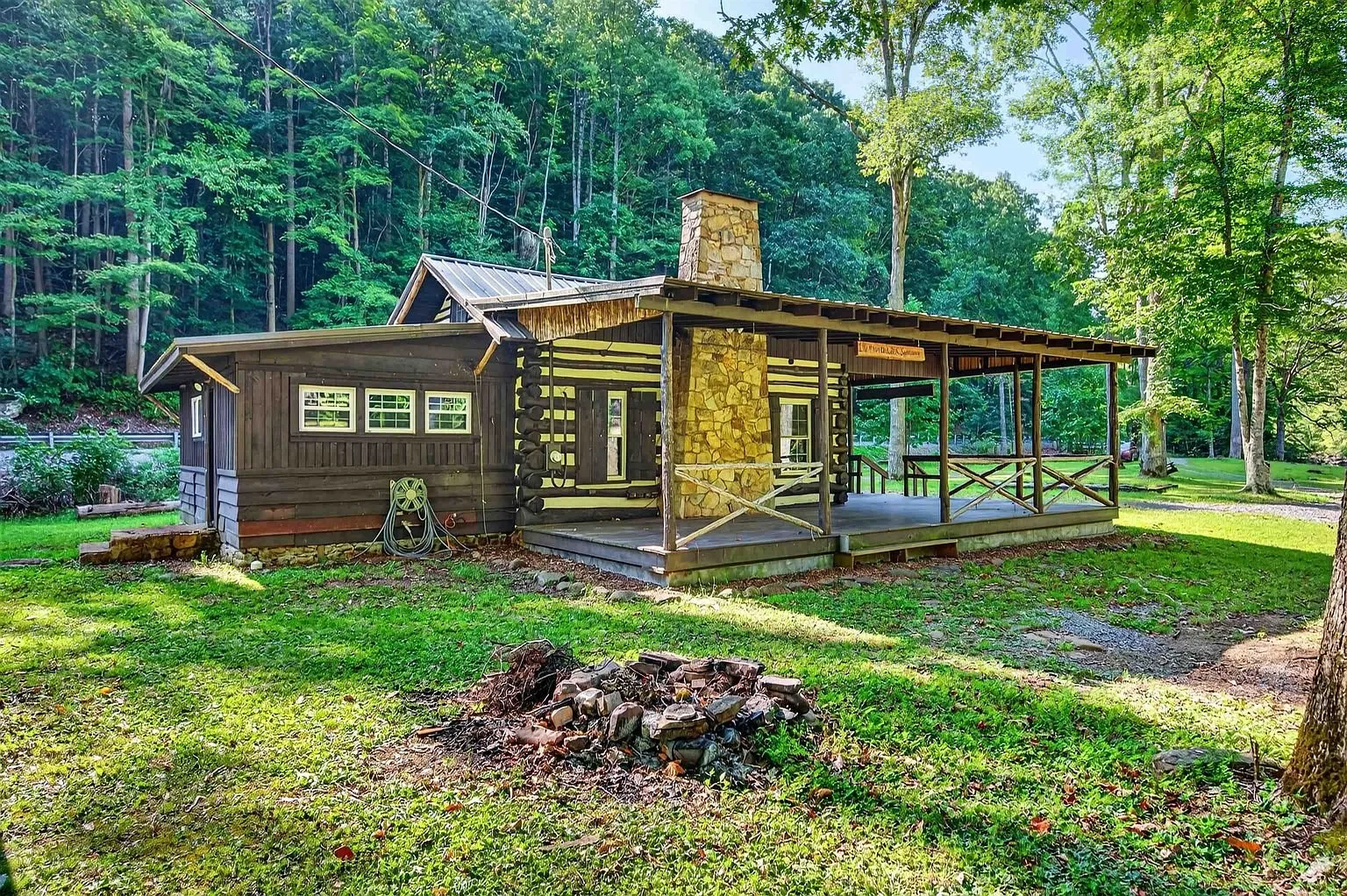 The side of the cabin with the porch wrapping around it