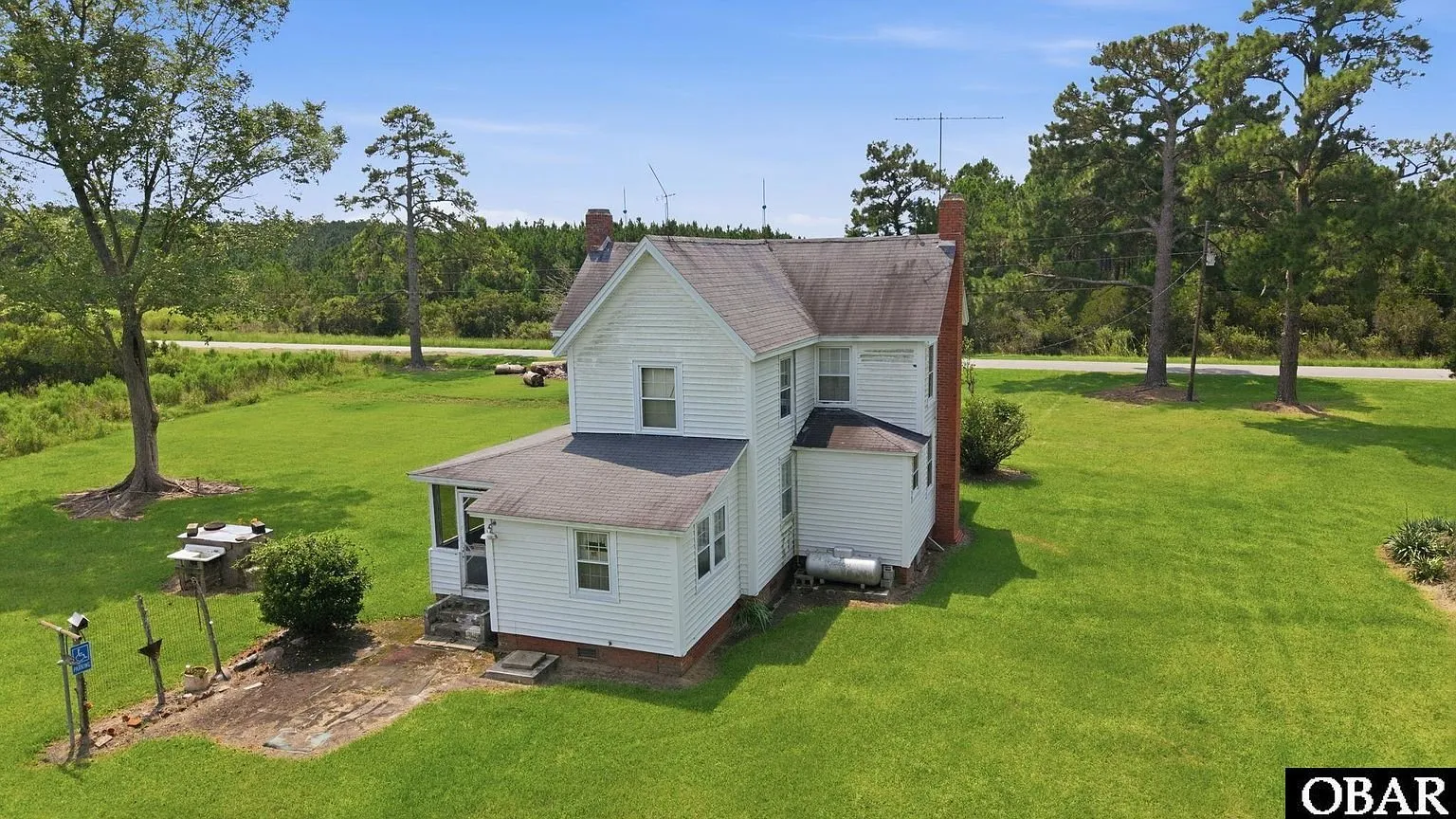 The kitchen wing and screened porch from the side yard