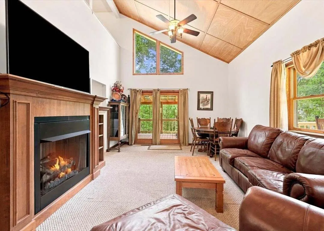 A second view of the vaulted living room, fireplace and seating area