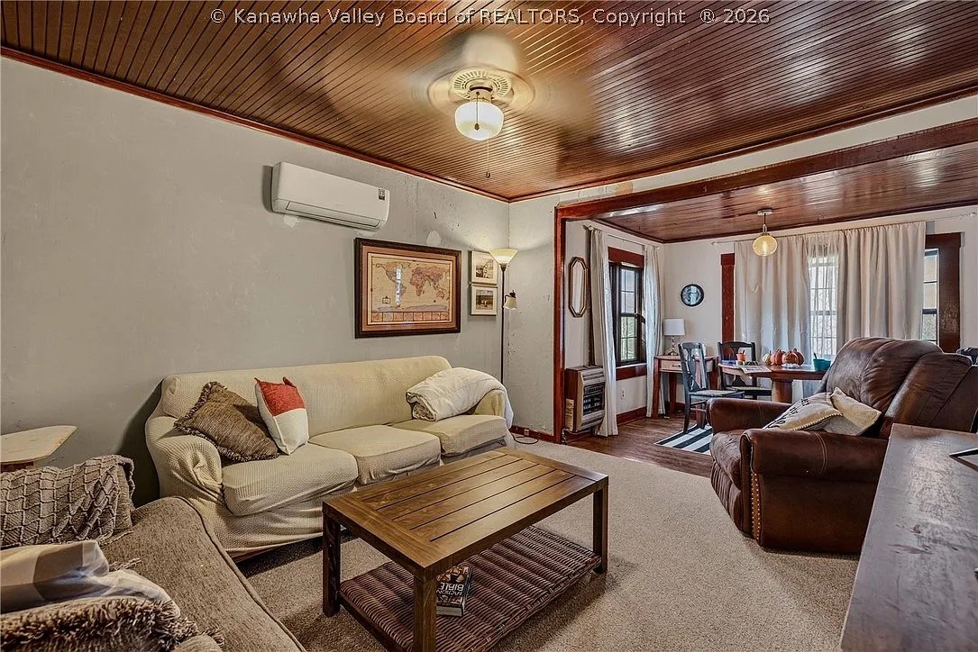 The same living room viewed toward the entry hallway and front door