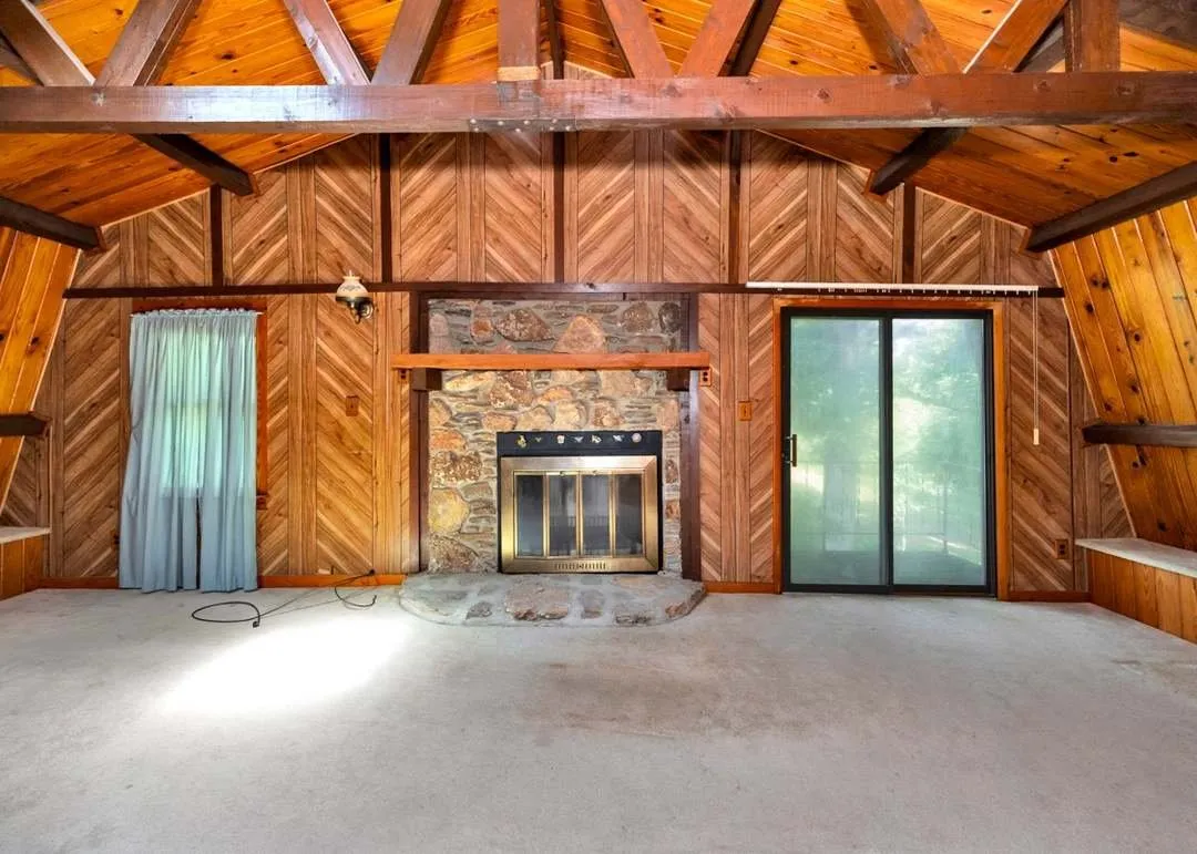 The kitchen with wood cabinetry and a stone-faced breakfast bar