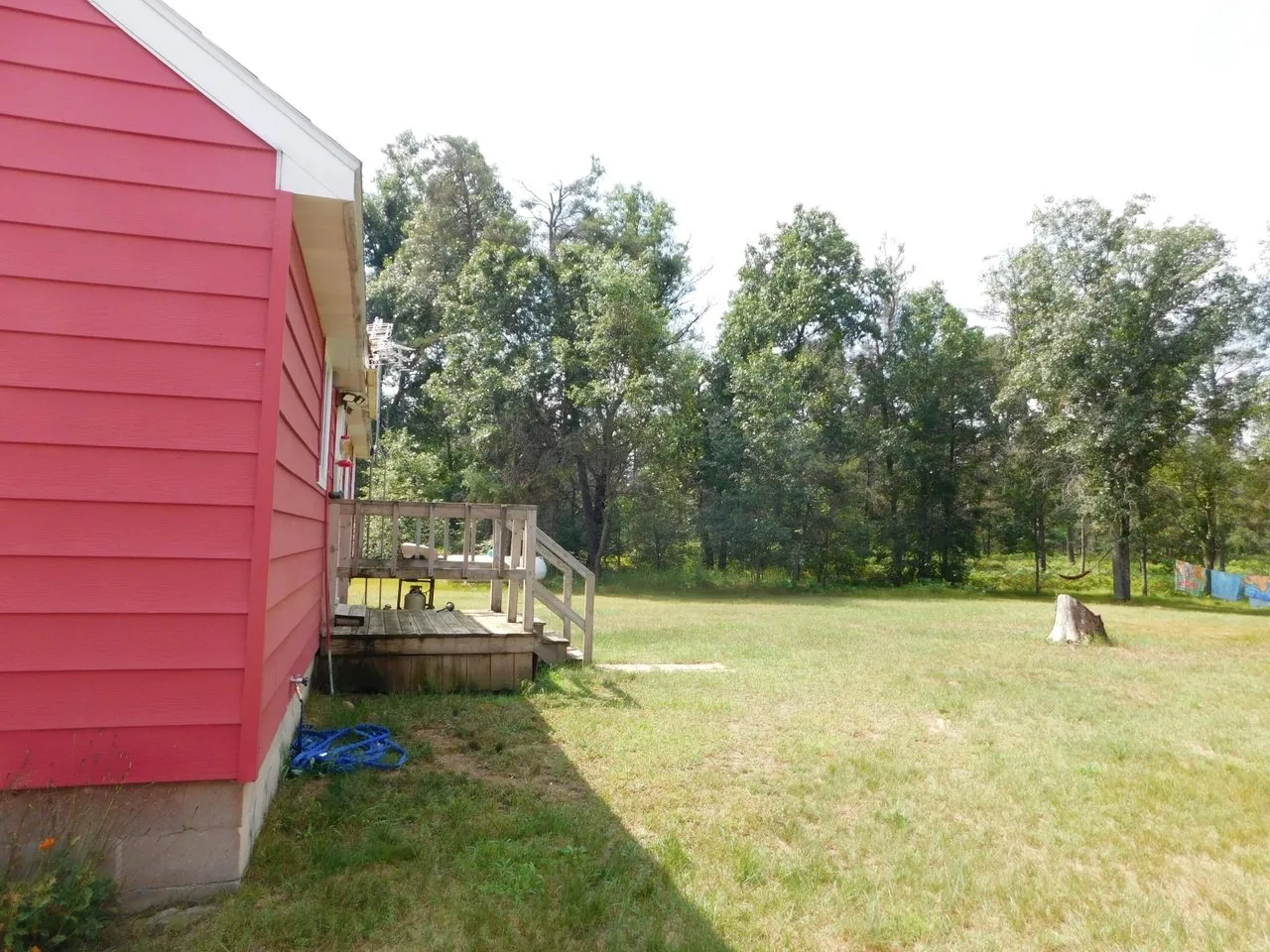 The back of the cabin with the deck and the mown yard beyond