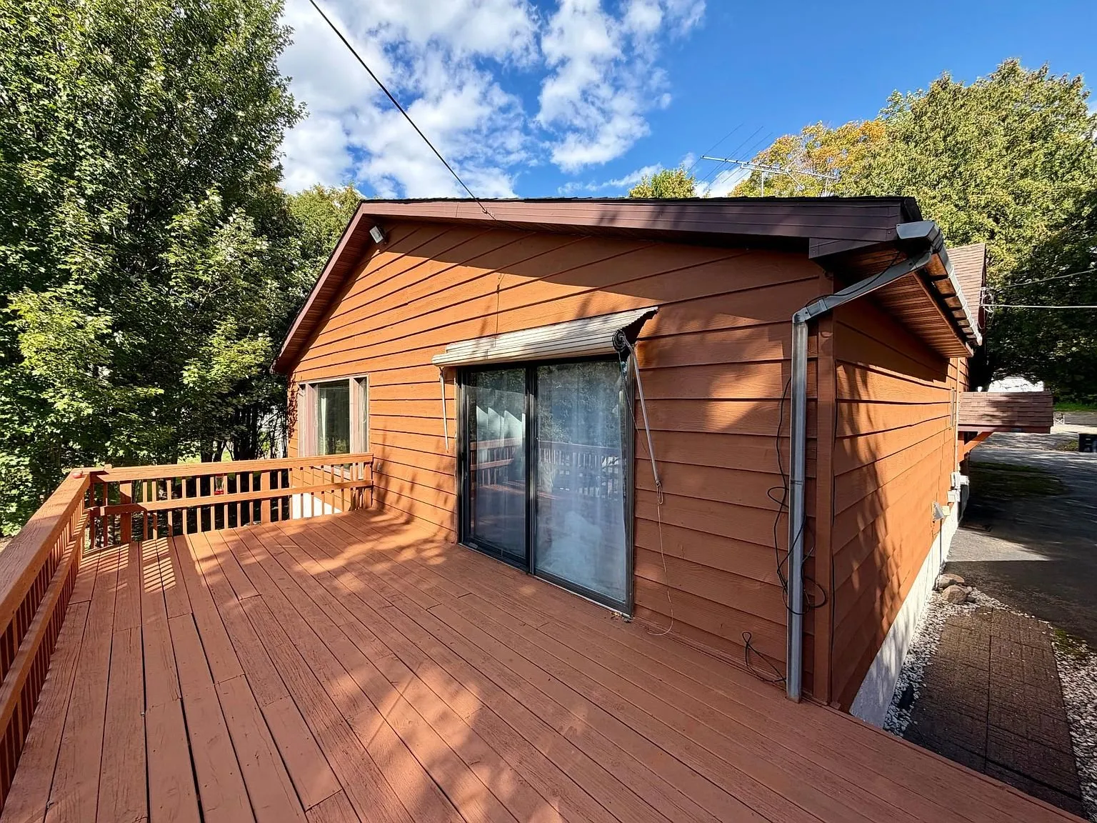 The deck with the sliding door and the rail