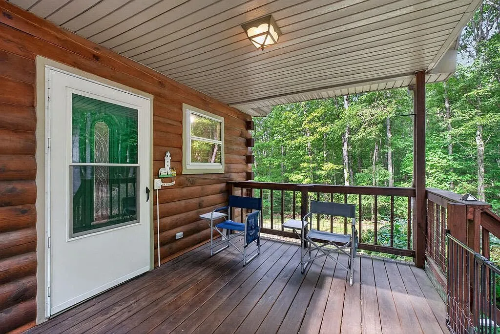 The outbuilding and RV hookup area beside the carport