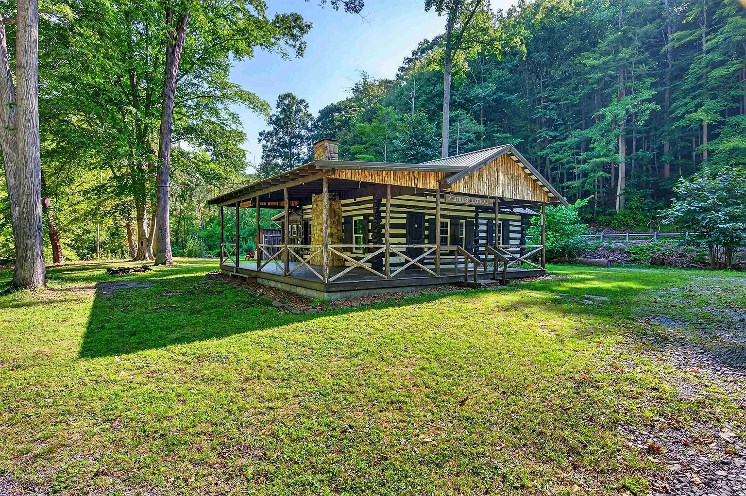The cabin from the lawn with the stone chimney
