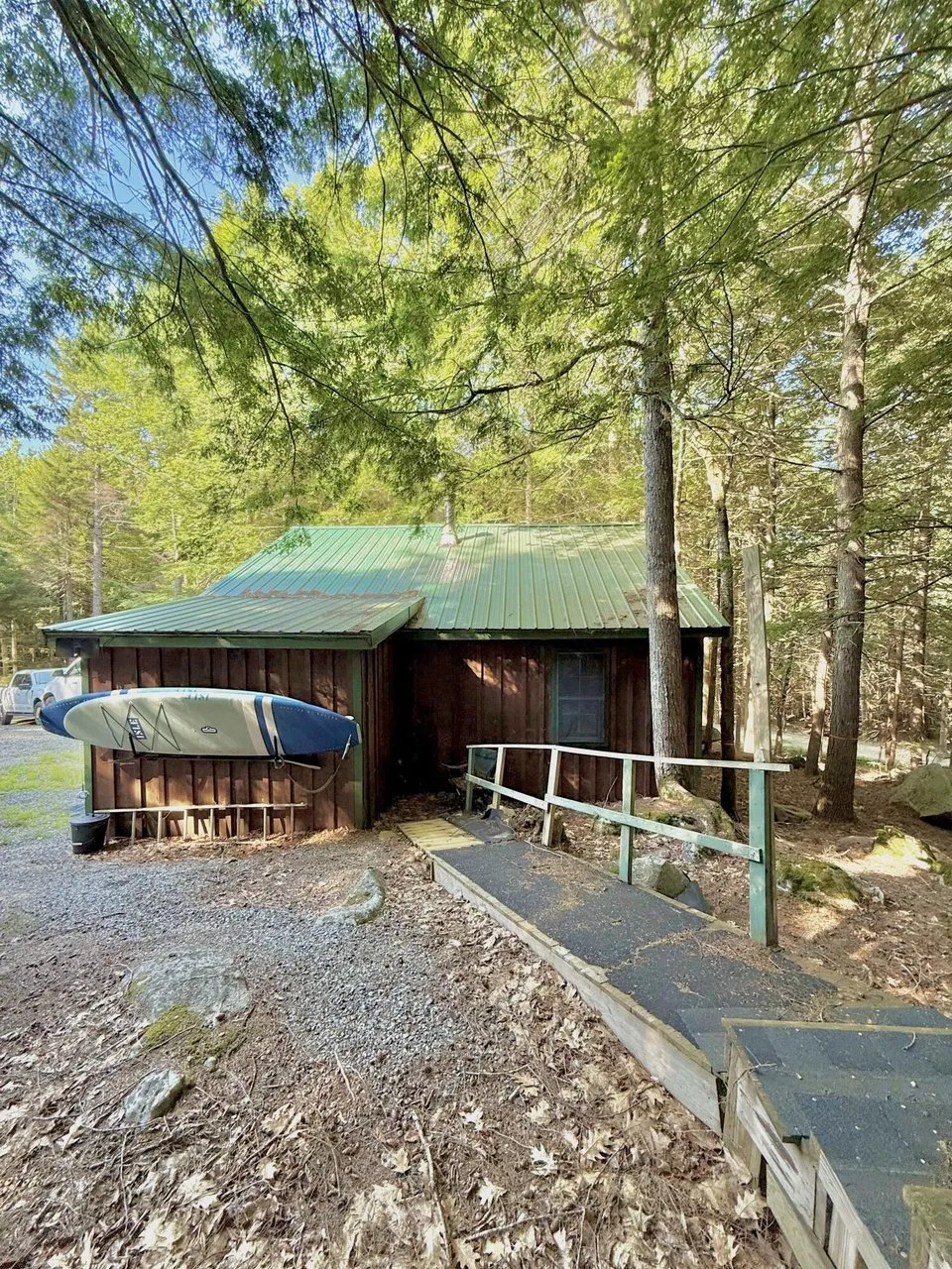The camp from the gravel drive under the spruce