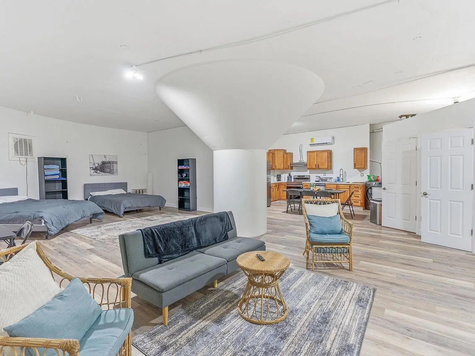 The main living space with sofas and a round support column