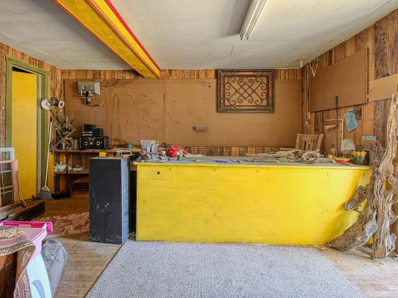 Inside the store: the yellow counter, bare walls and stacked boxes