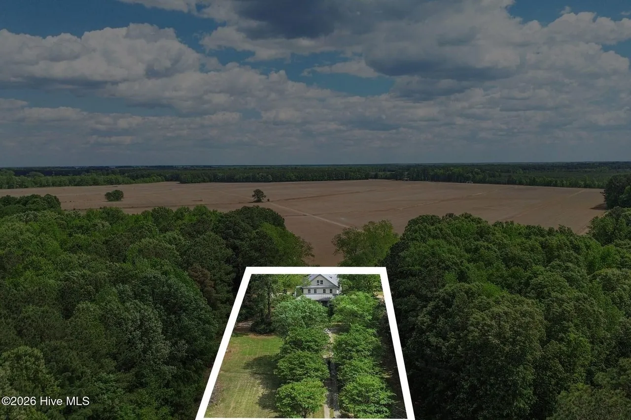 Aerial with the listing's outline of the 2.69-acre parcel drawn around the house