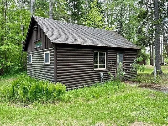 The second cabin with its log walls and gable window
