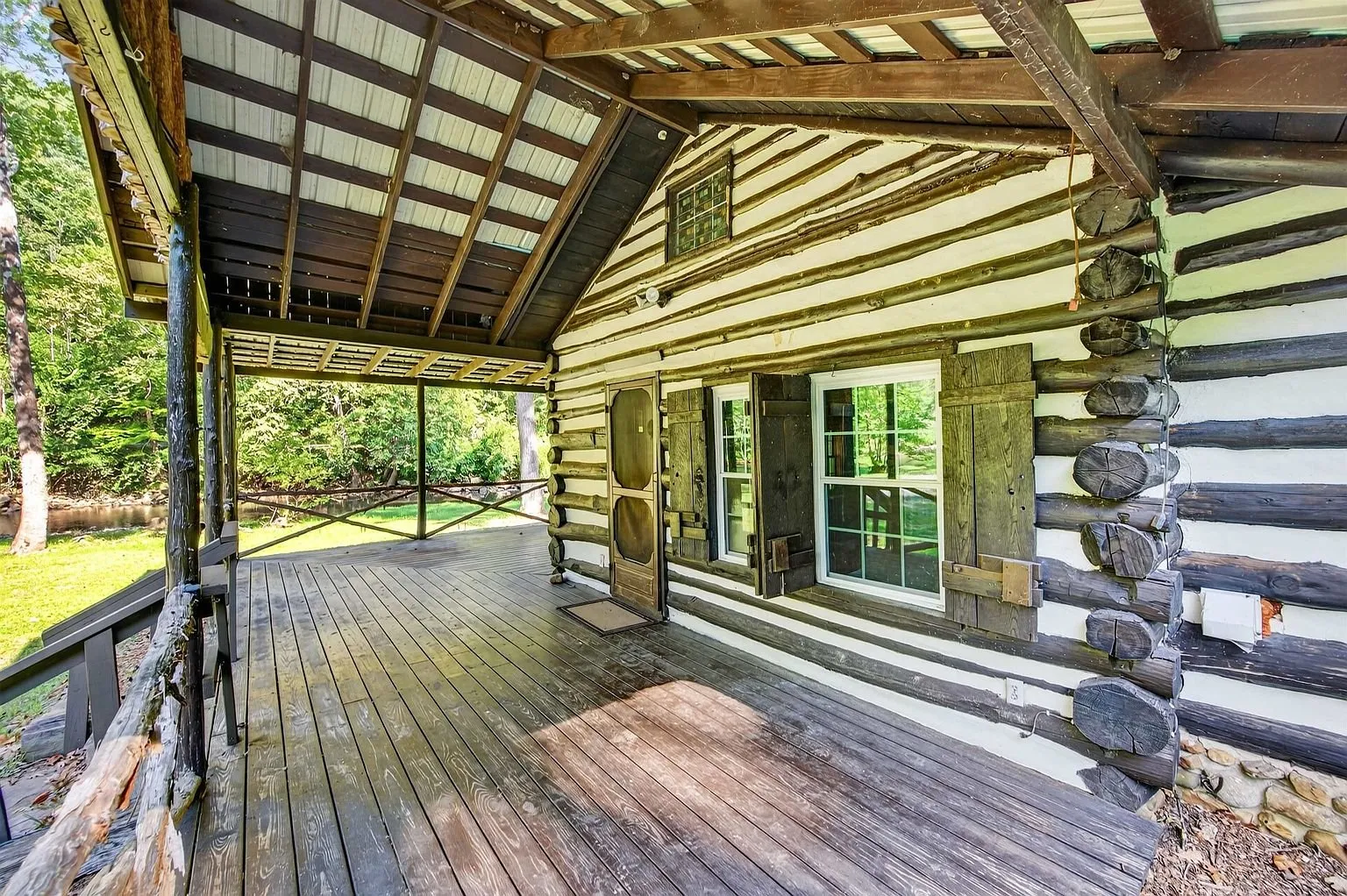 The covered porch running along the front of the cabin