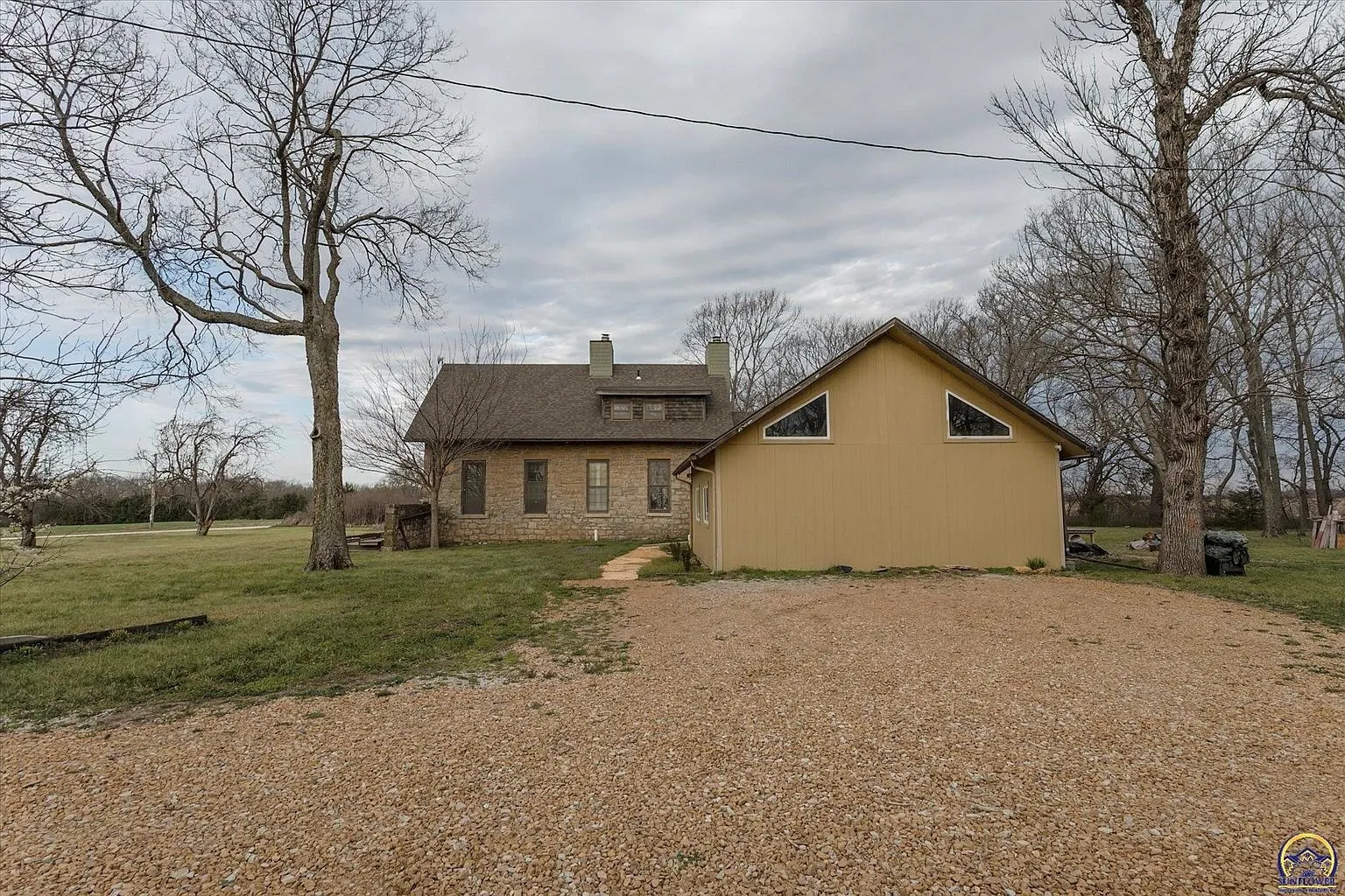 The gravel drive to the addition's gable end