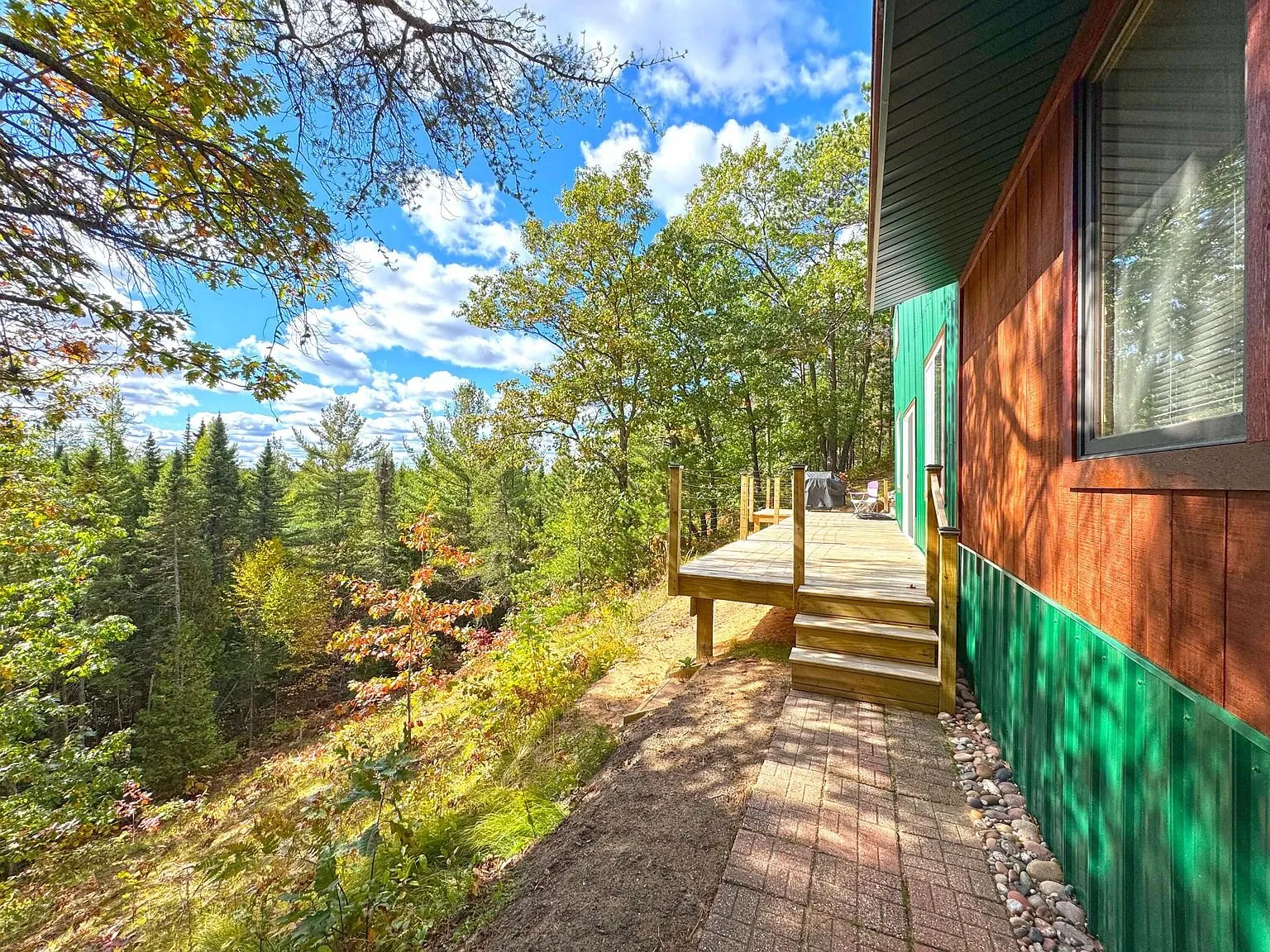 The wooden walkway curving up to the cabin door