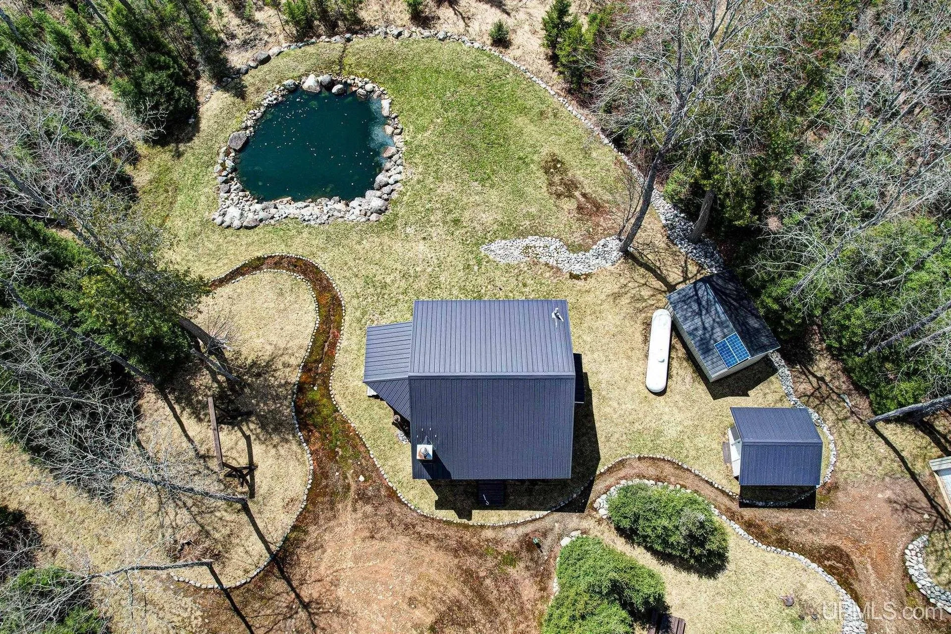 Aerial straight down on the pond, the cabin and the outbuildings