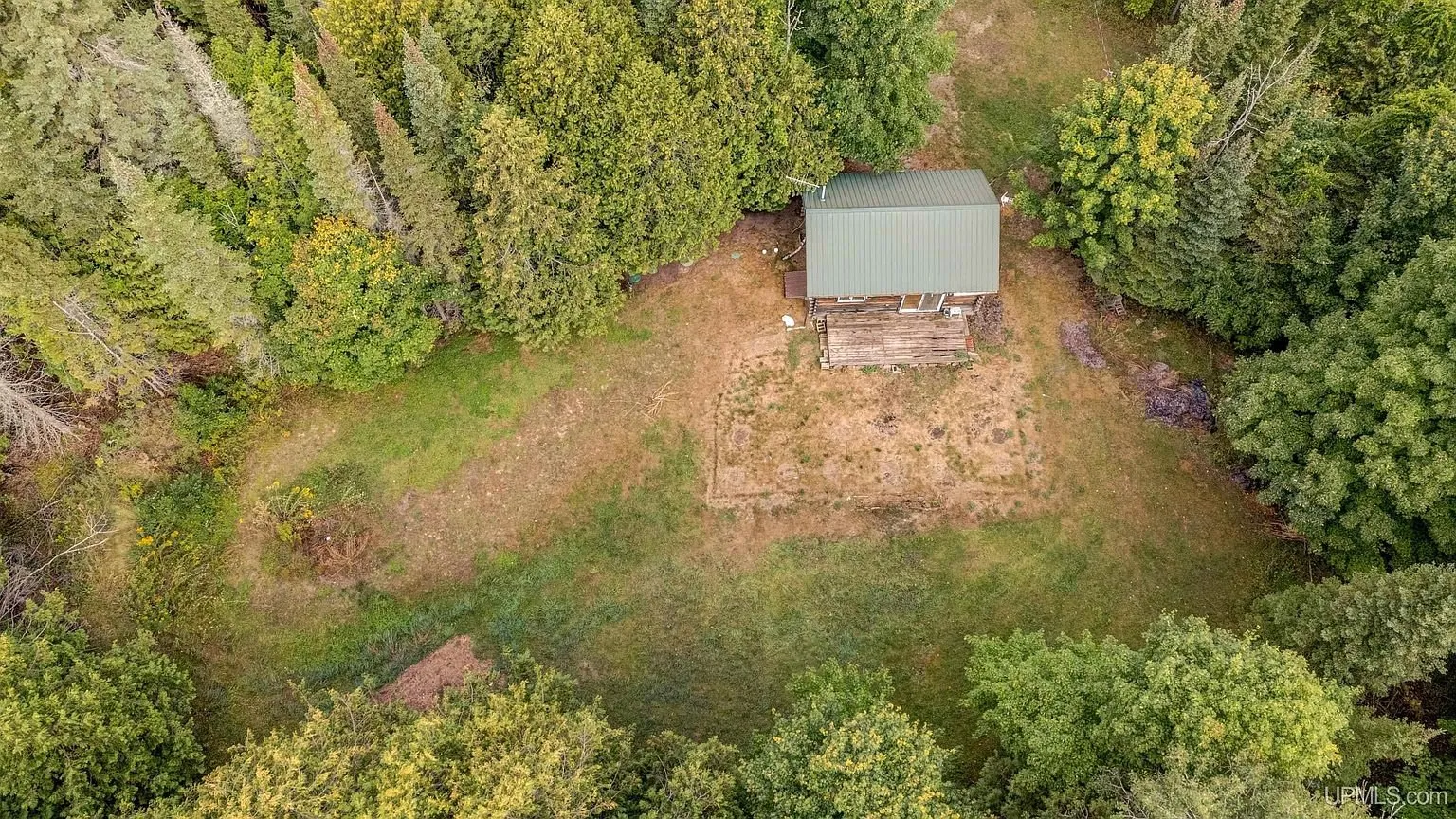 Aerial of the clearing, the cottage and the shed from above