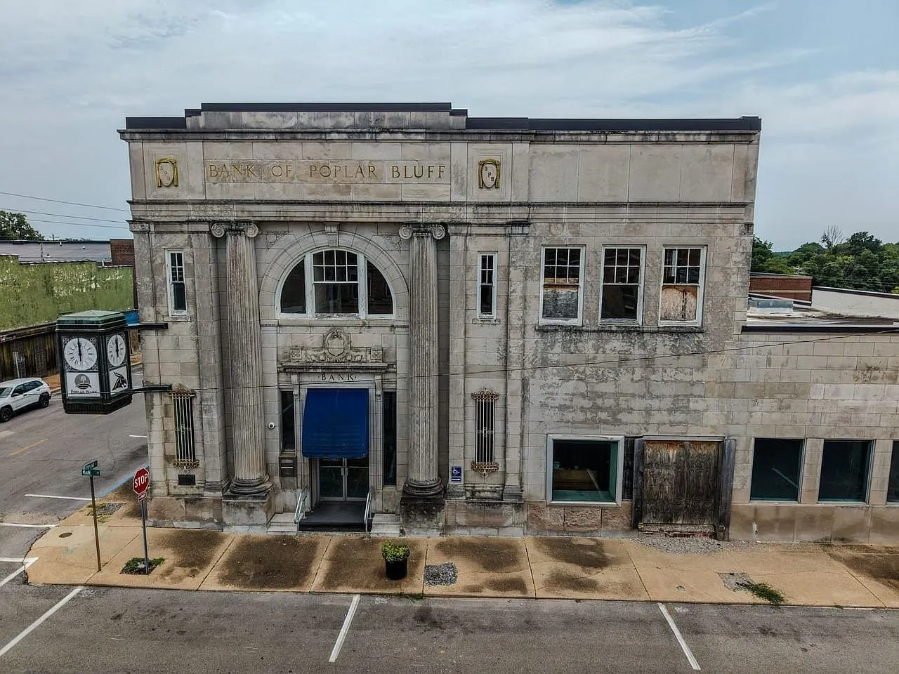Aerial straight on to the front facade with its columns and arched window