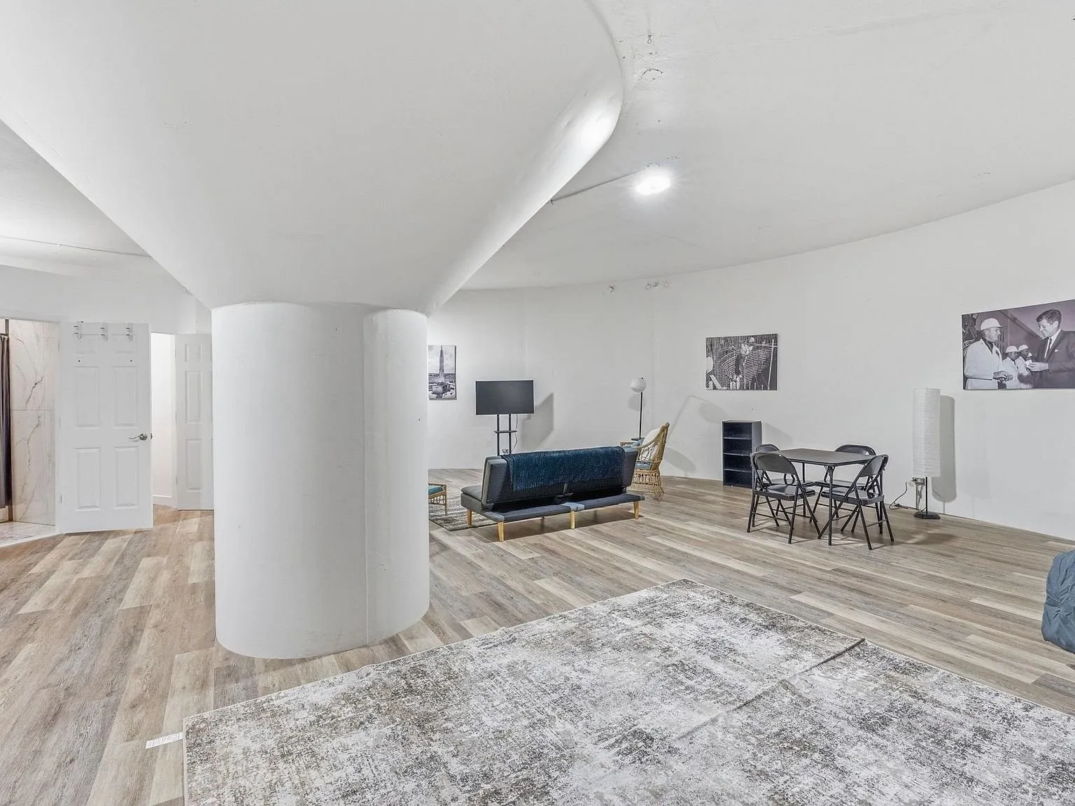 The open living area with the curved ceiling and a dining table