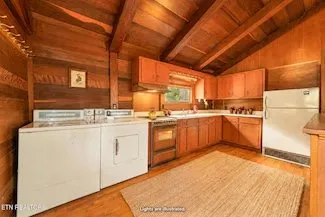 The washer and dryer built into the kitchen's cabinetry, from the same virtually staged listing gallery