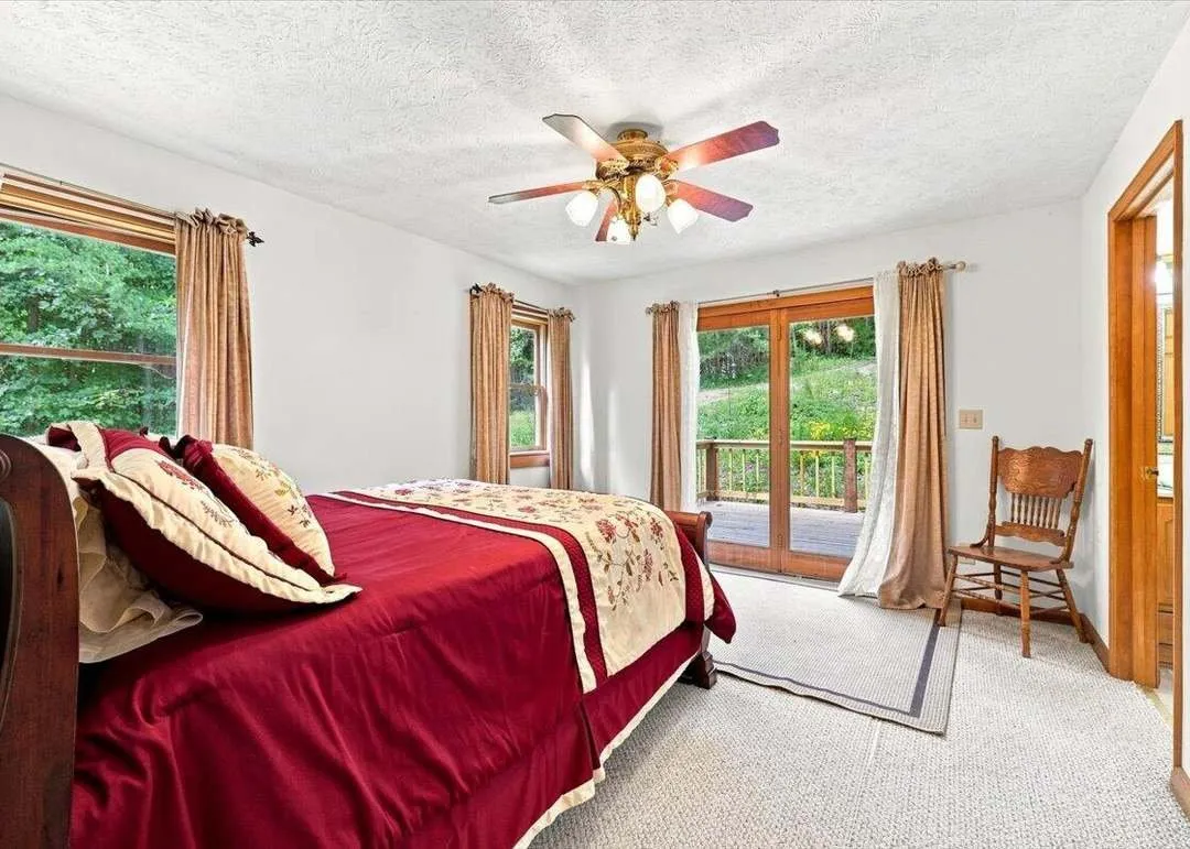 The main-level primary bedroom with wood flooring and natural light