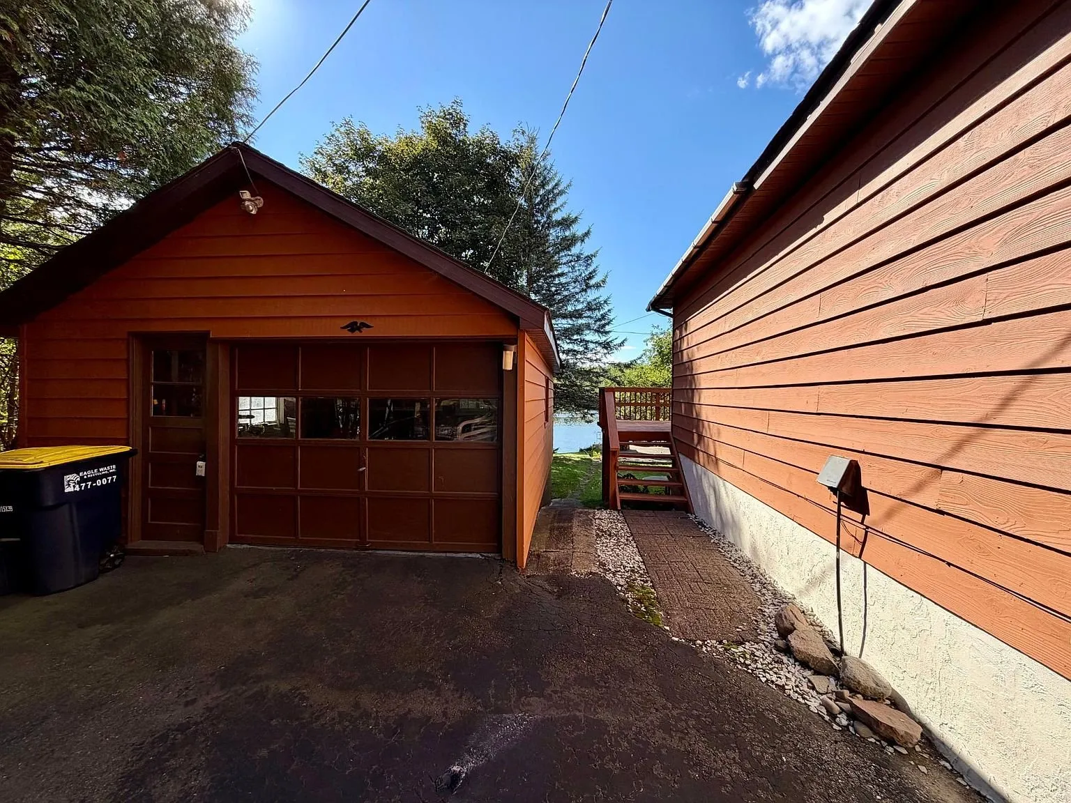 The garage with its door open beside the house